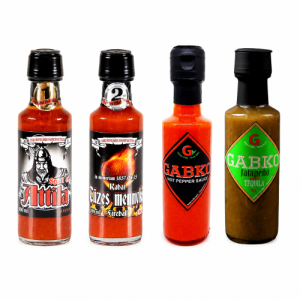 Four hot sauce bottles lined up on a white background, including two with illustrated labels and two GABKO sauces (hot pepper and jalapeño tequila).